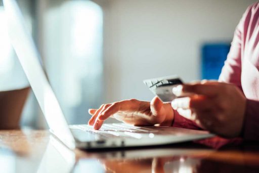 Woman shopping with a credit card at home